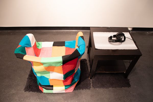 Priyanka Na, Harmanpreet Kaur,
Burnout Chair,
2025,
Plastic chair, quilt, tinfoil, headphones, side table, rug, 
5’ x 5’ x 3’